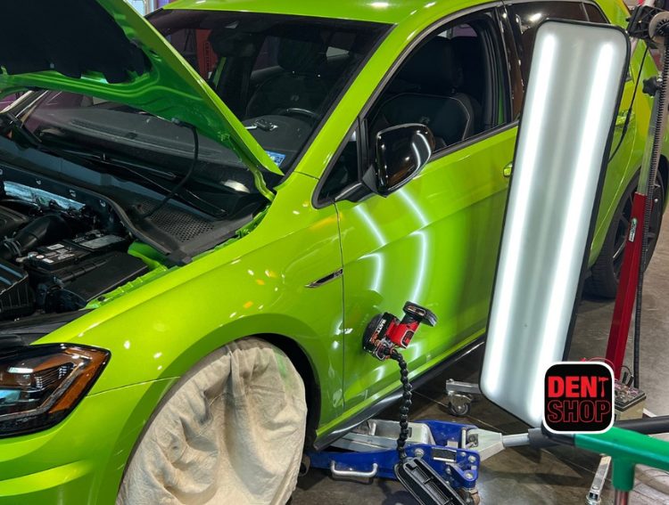 green car paintless dent repair at dent shop